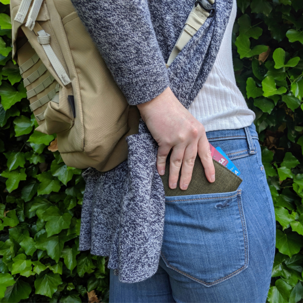person putting their wallet away