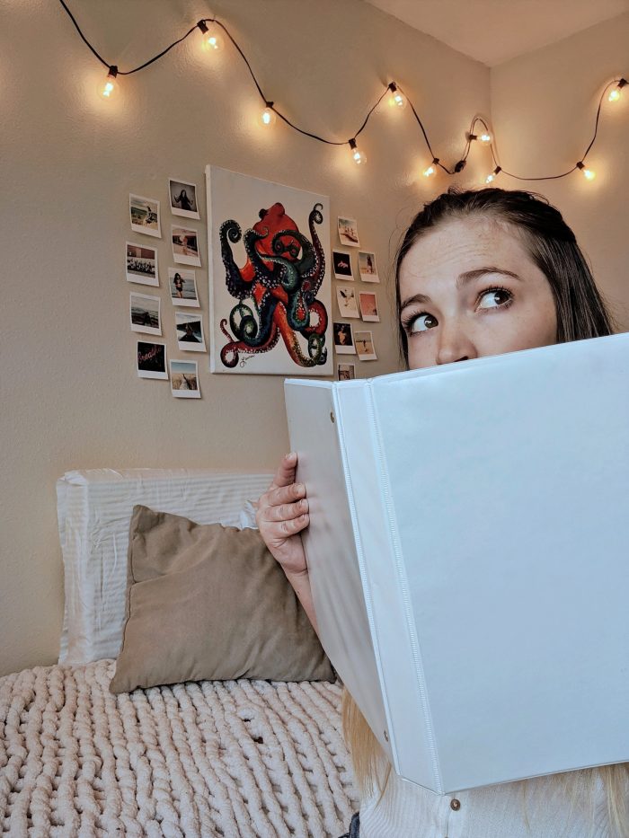 selfie of someone looking at a binder