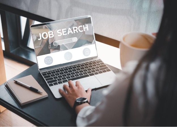 person looking at job search on a laptop