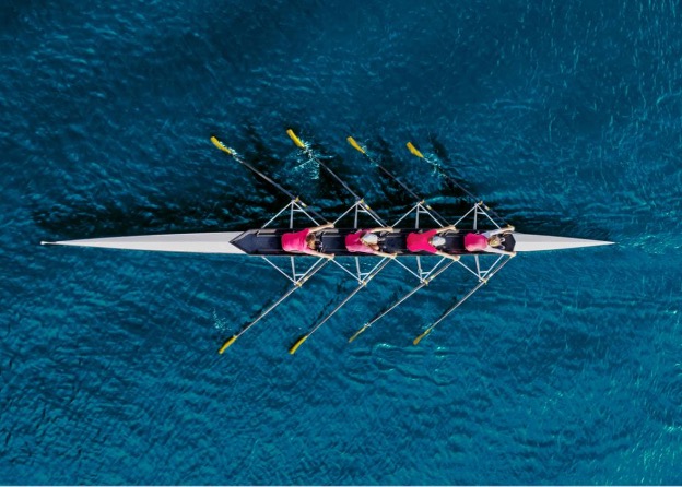 Crew team rowing.